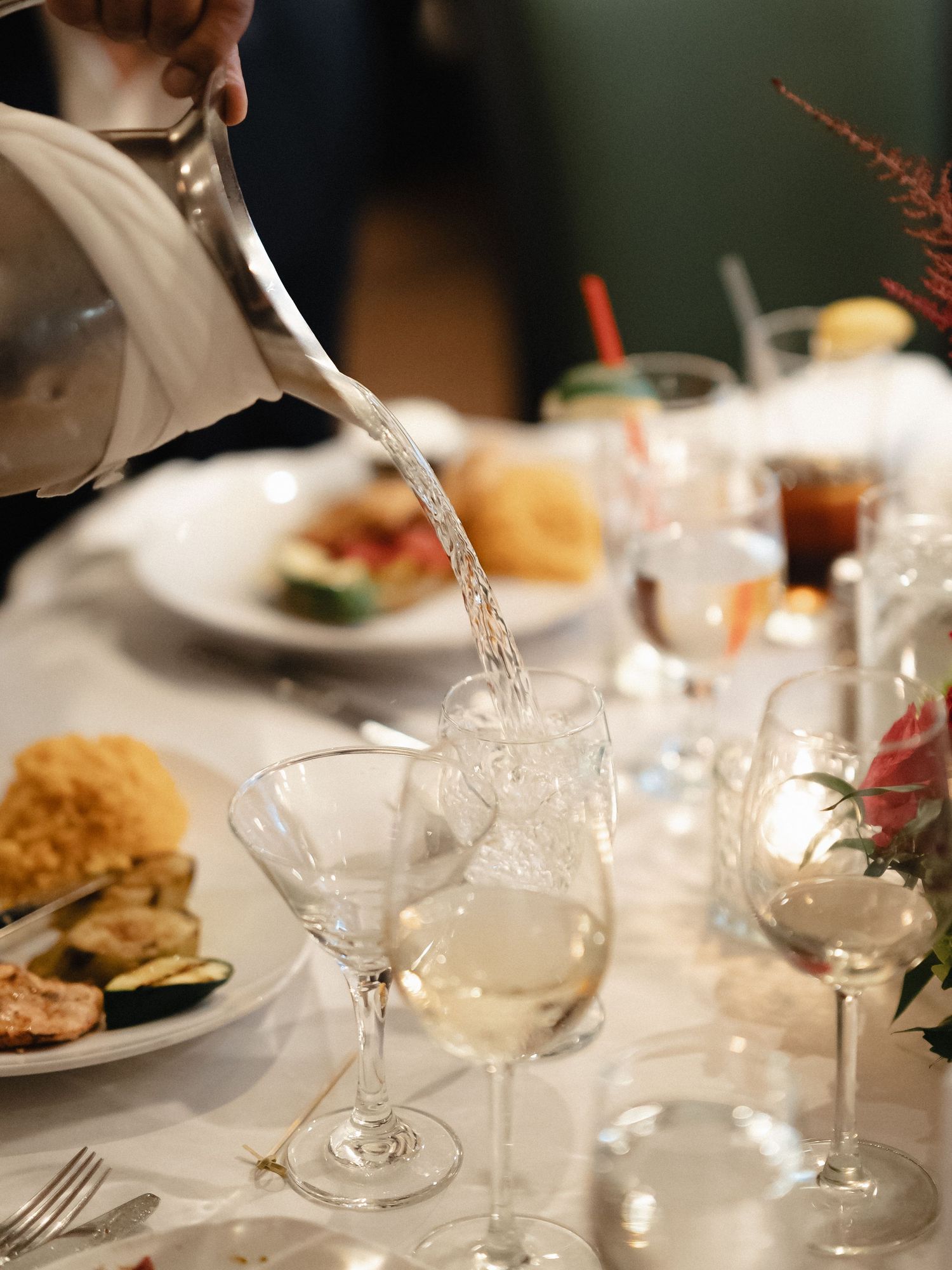 Crystal wine glasses and place settings on an elegantly set dining table.