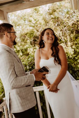 Candid moments of a bride and groom sharing laughter during their wedding ceremony.