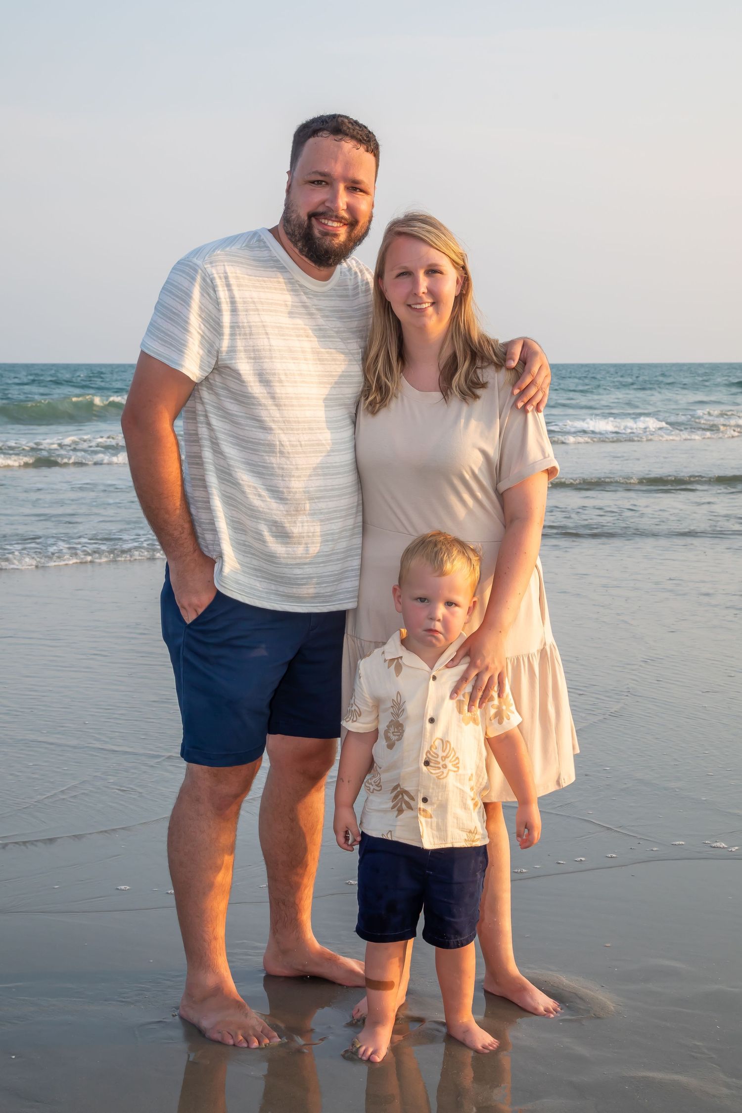 A family enjoying a sunset moment together on the beach.