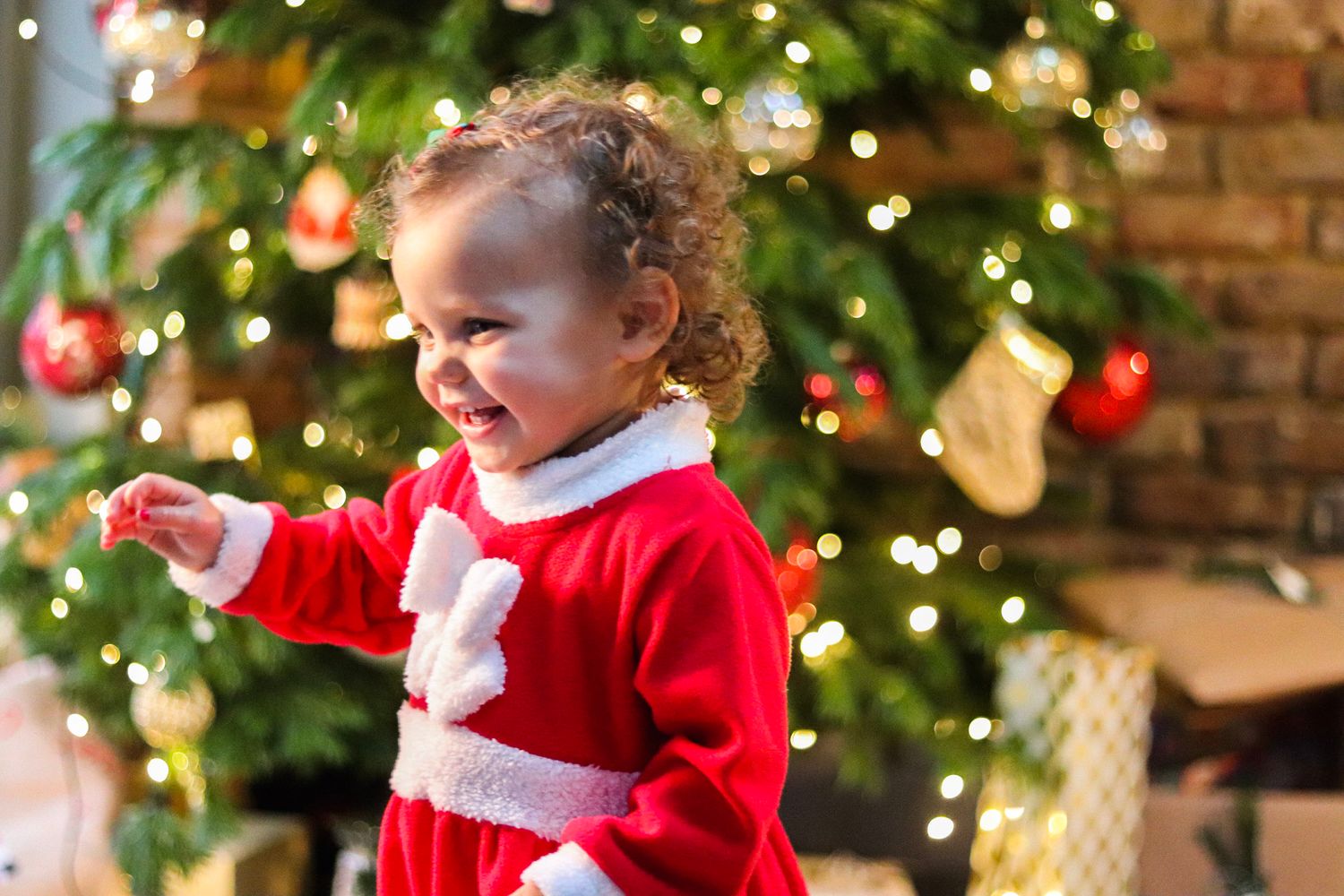 Girl toddler in christmas costume with twinkling lights in Esher, Surrey