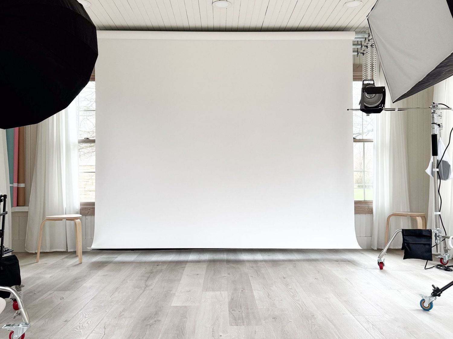 Empty white studio space with clean white walls and hardwood flooring.