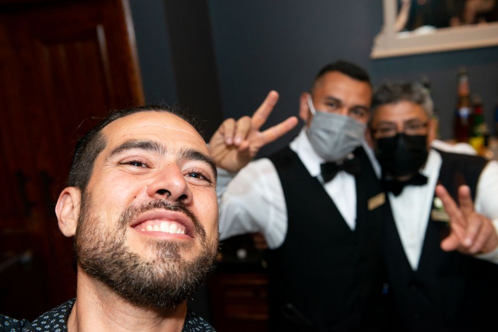 A celebratory selfie with people in formal attire making peace signs.