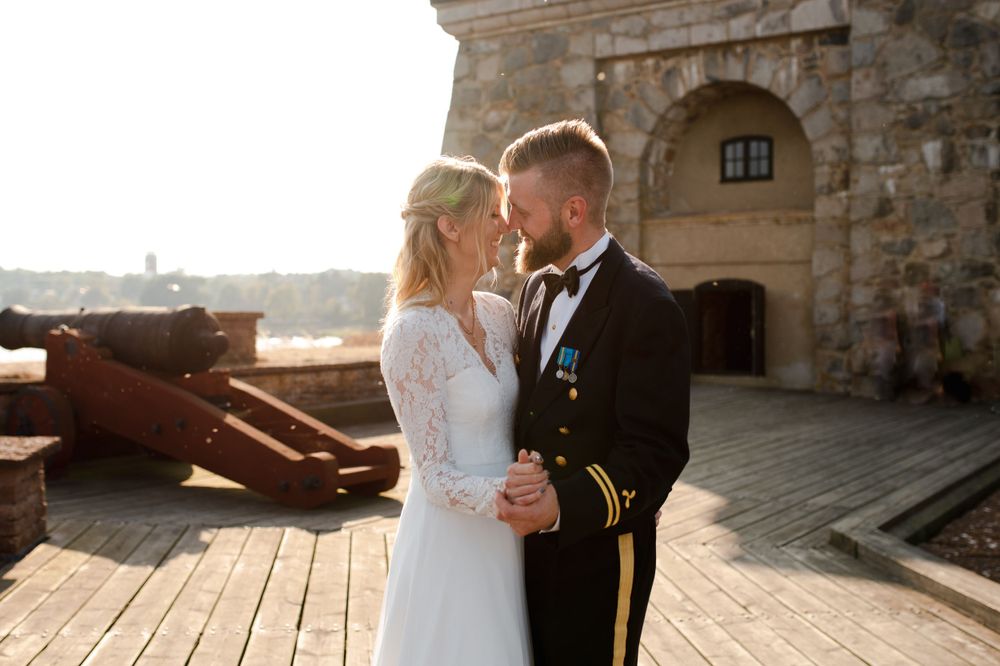 A romantic sunset moment at a historic fortress with vintage cannons.
