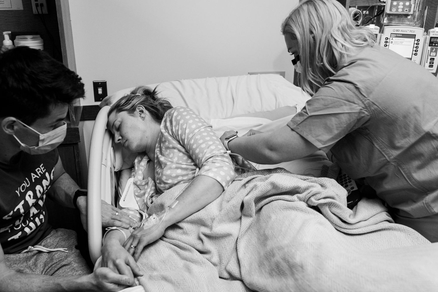 Woman in labor being comforted by her nurse and her husband during a contraction at her Louisville, CO birth