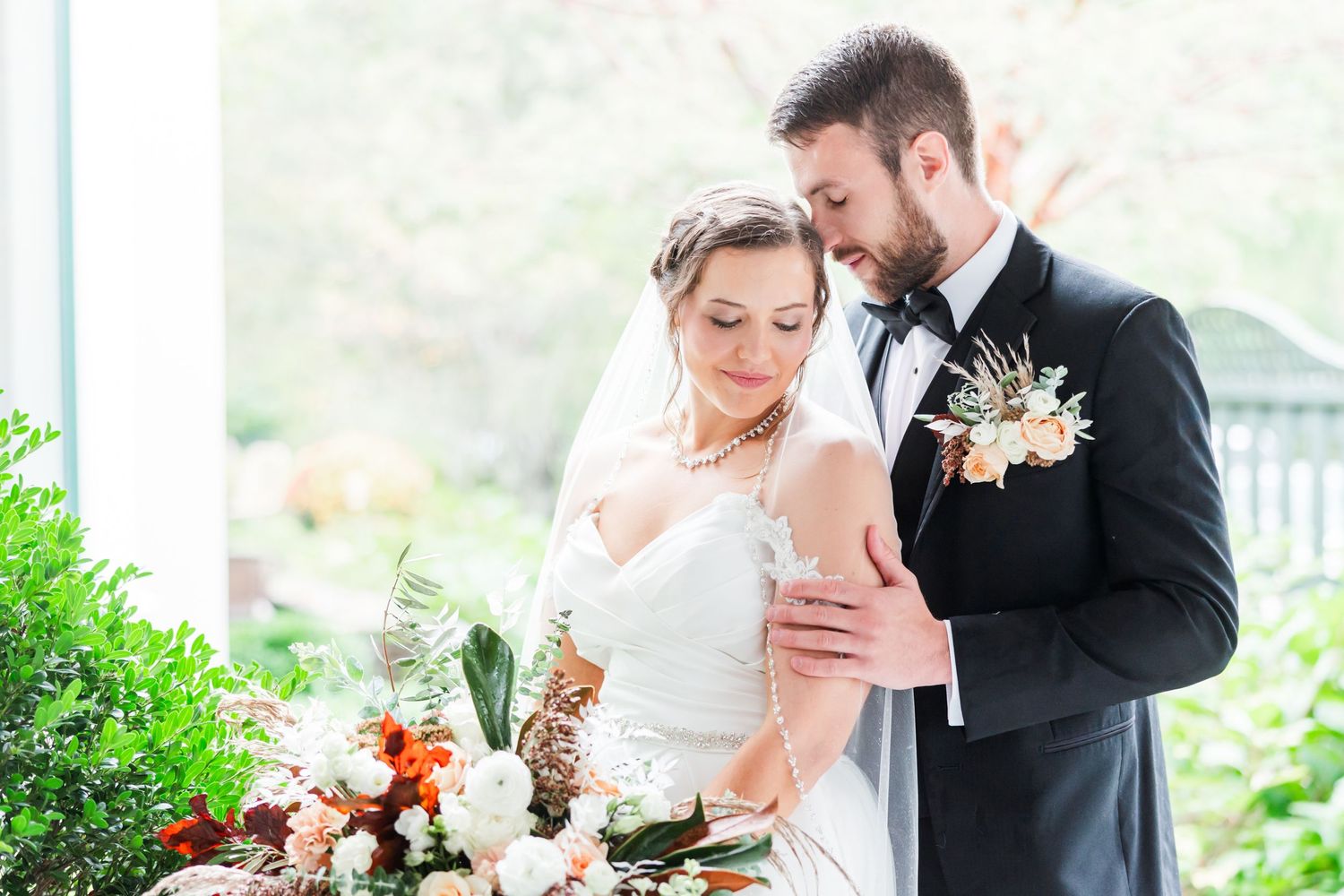 A romantic moment shared between a couple during their outdoor garden wedding celebration.