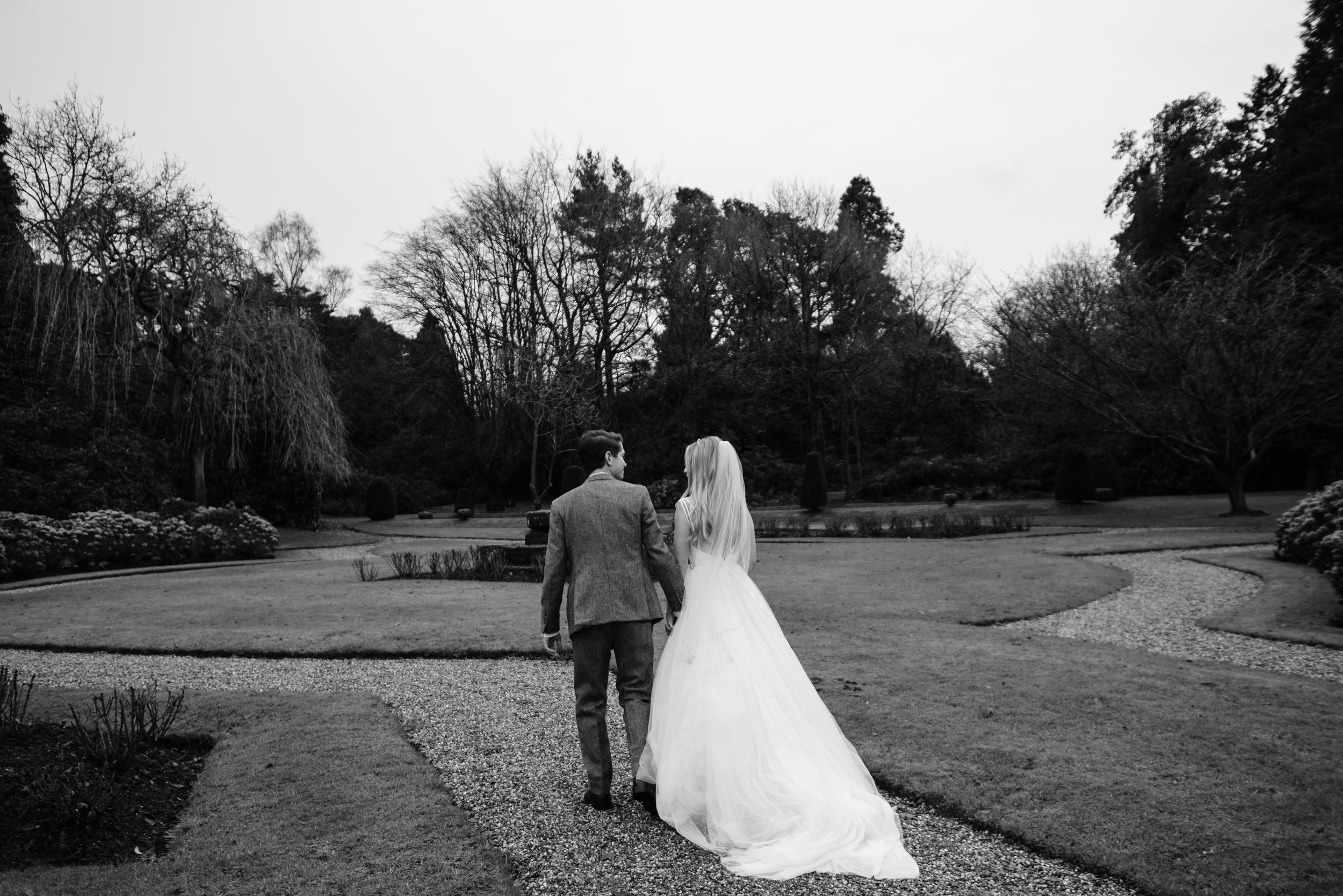 Bride and Groom walking at the beautiful garden of Hawkstone Hall