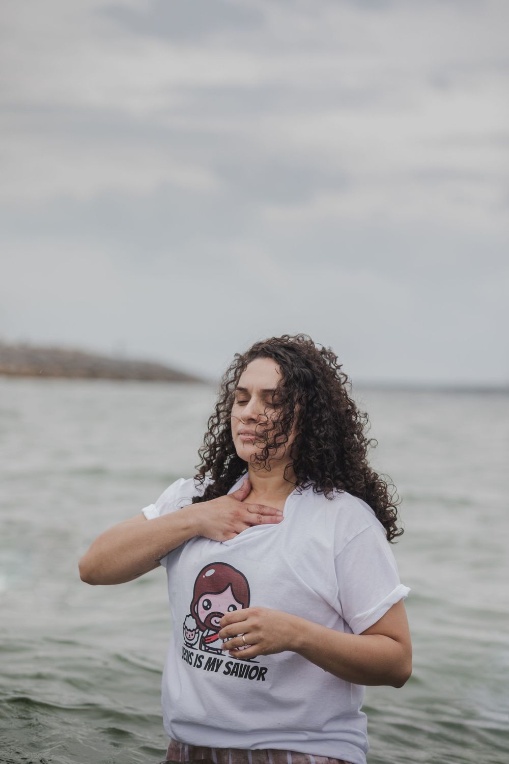 woman having a baptising ceremony in Salhill, Galway, Ireland, saying prayers, singing and celebrating this special moment with her friends