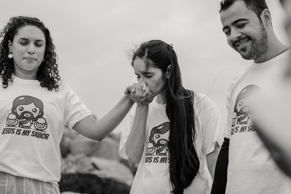 woman having a baptising ceremony in Salhill, Galway, Ireland, saying prayers, singing and celebrating this special moment with her friends