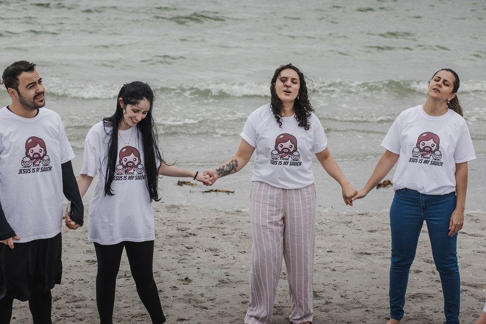 woman having a baptising ceremony in Salhill, Galway, Ireland, saying prayers, singing and celebrating this special moment with her friends
