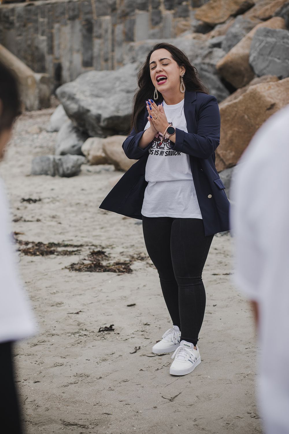 woman having a baptising ceremony in Salhill, Galway, Ireland, saying prayers, singing and celebrating this special moment with her friends