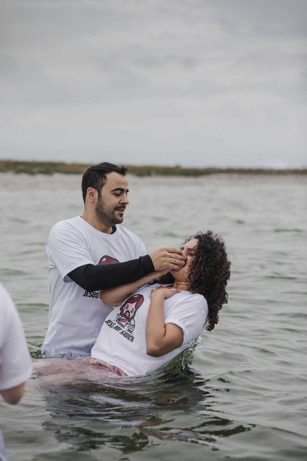 woman having a baptising ceremony in Salhill, Galway, Ireland, saying prayers, singing and celebrating this special moment with her friends