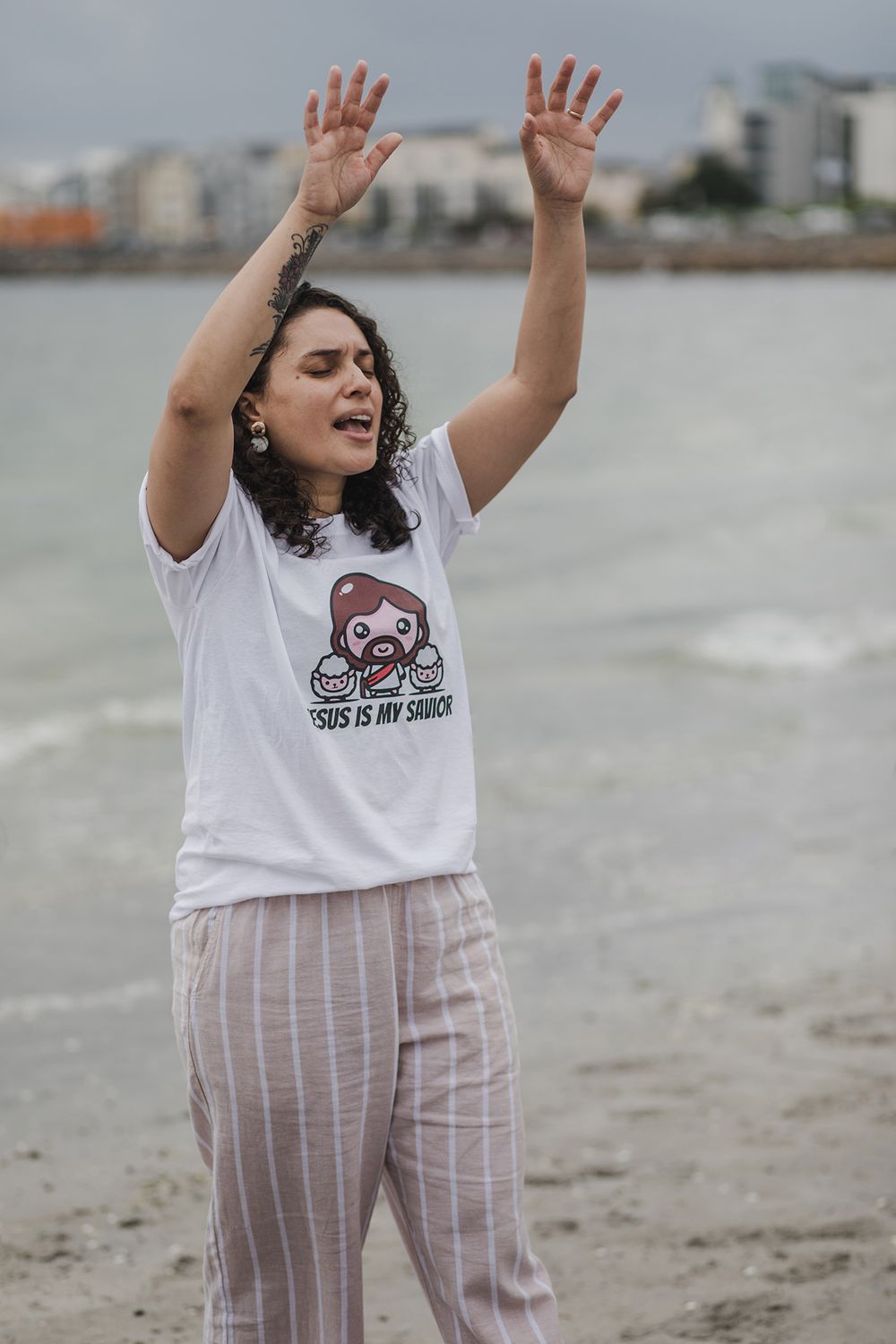 woman having a baptising ceremony in Salhill, Galway, Ireland, saying prayers, singing and celebrating this special moment with her friends