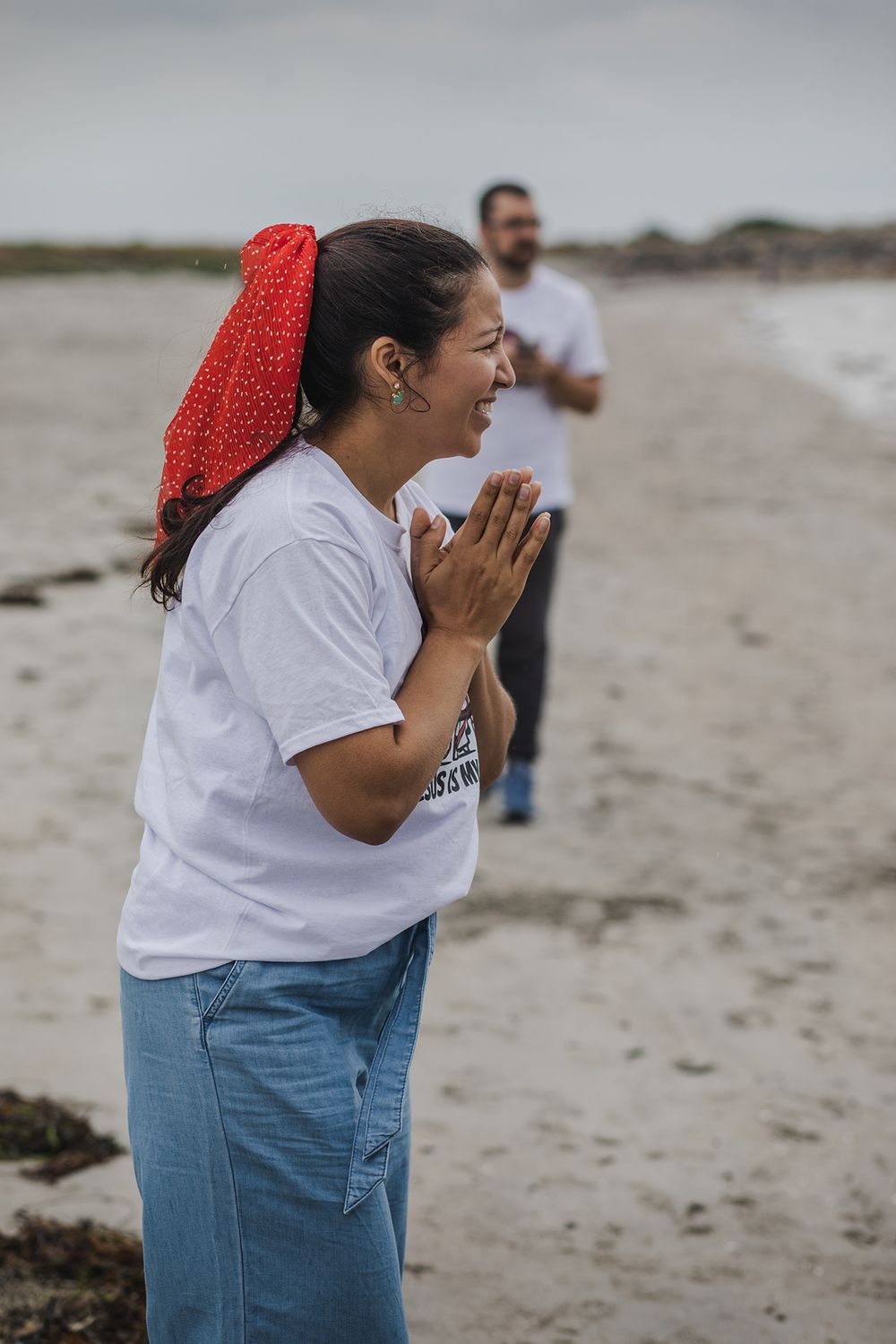 woman having a baptising ceremony in Salhill, Galway, Ireland, saying prayers, singing and celebrating this special moment with her friends
