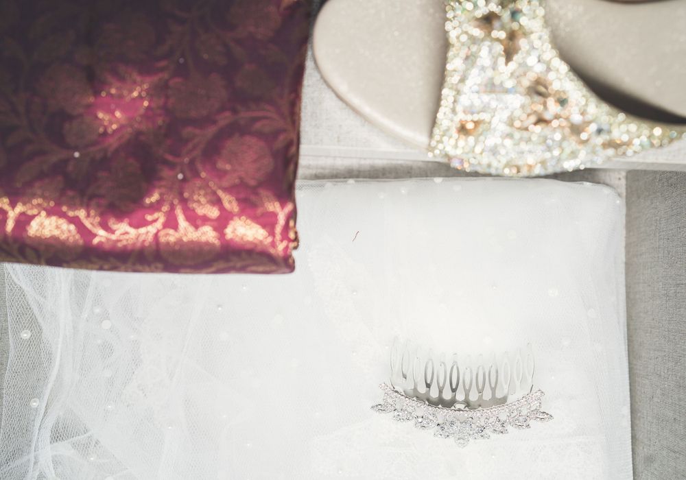 False eyelashes displayed on a white surface with burgundy fabric in the background.