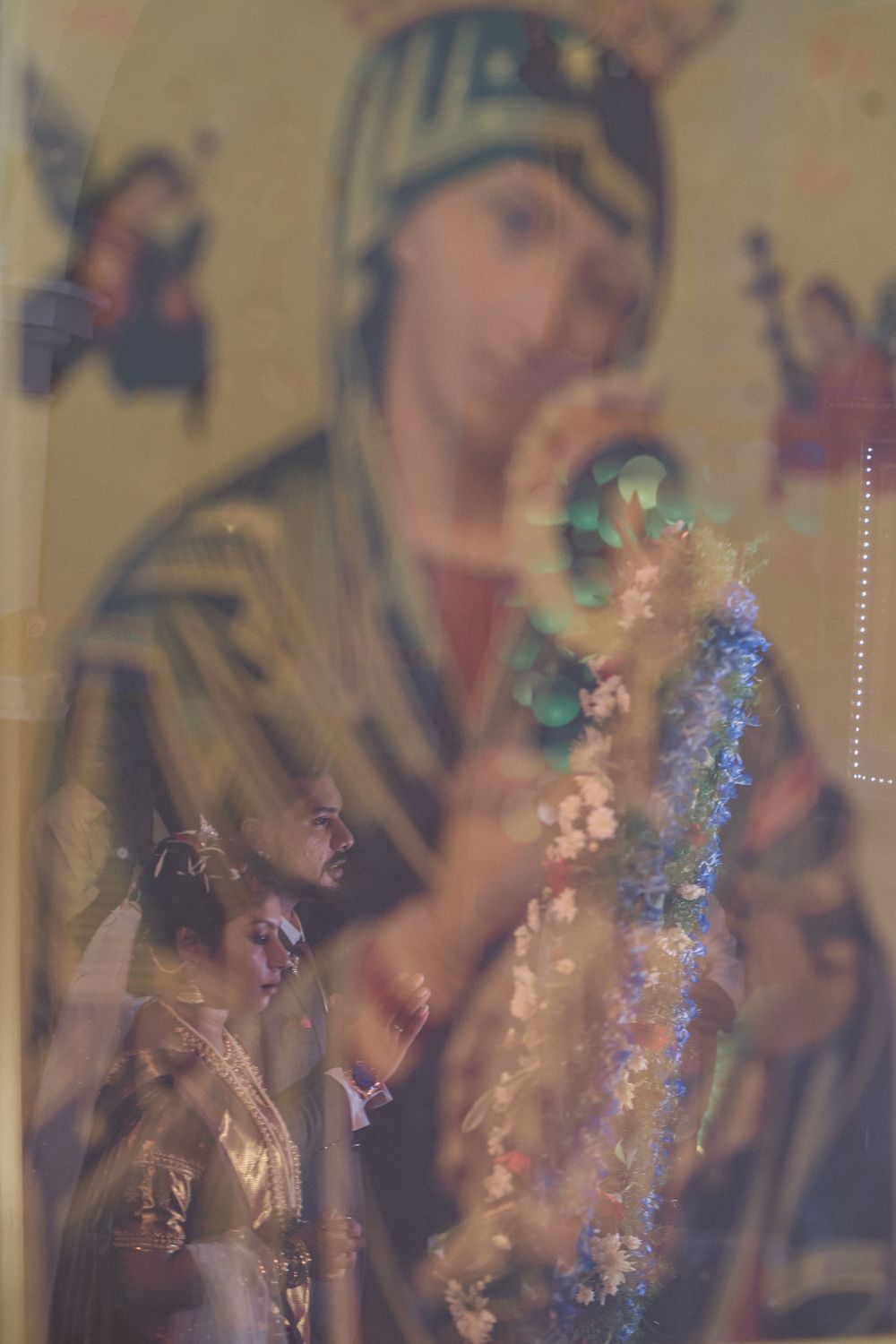 Double exposure of religious icon overlaid with wedding ceremony details.