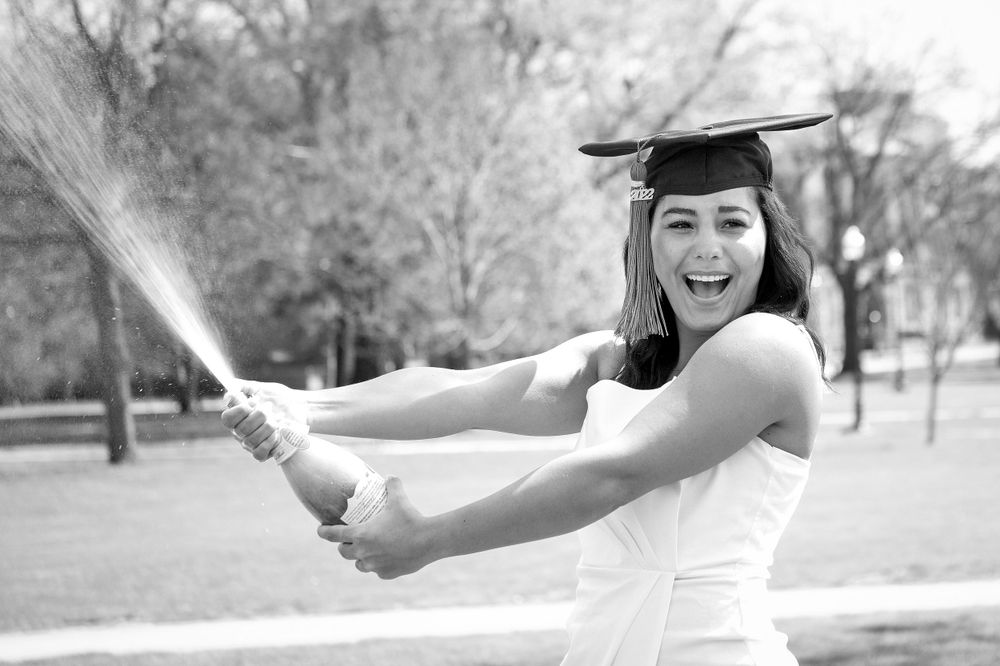 Ohio State graduate pops a bottle of champagne to celebrate her college graduation.