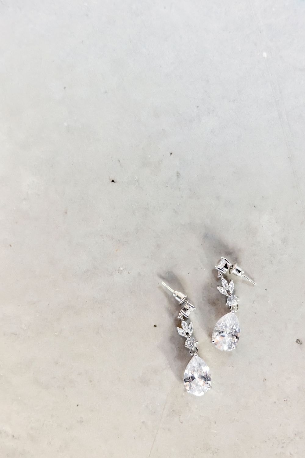 Crystal stud earrings sparkling against white background.