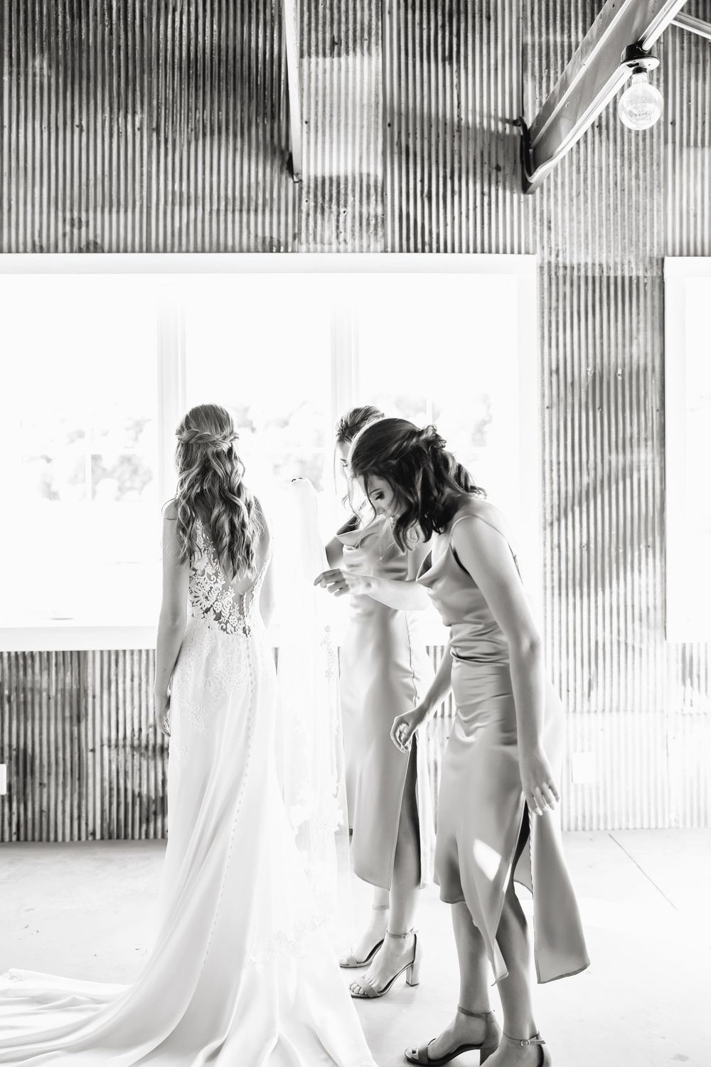 Black and white wedding photography sequence showing romantic moments in an industrial setting.