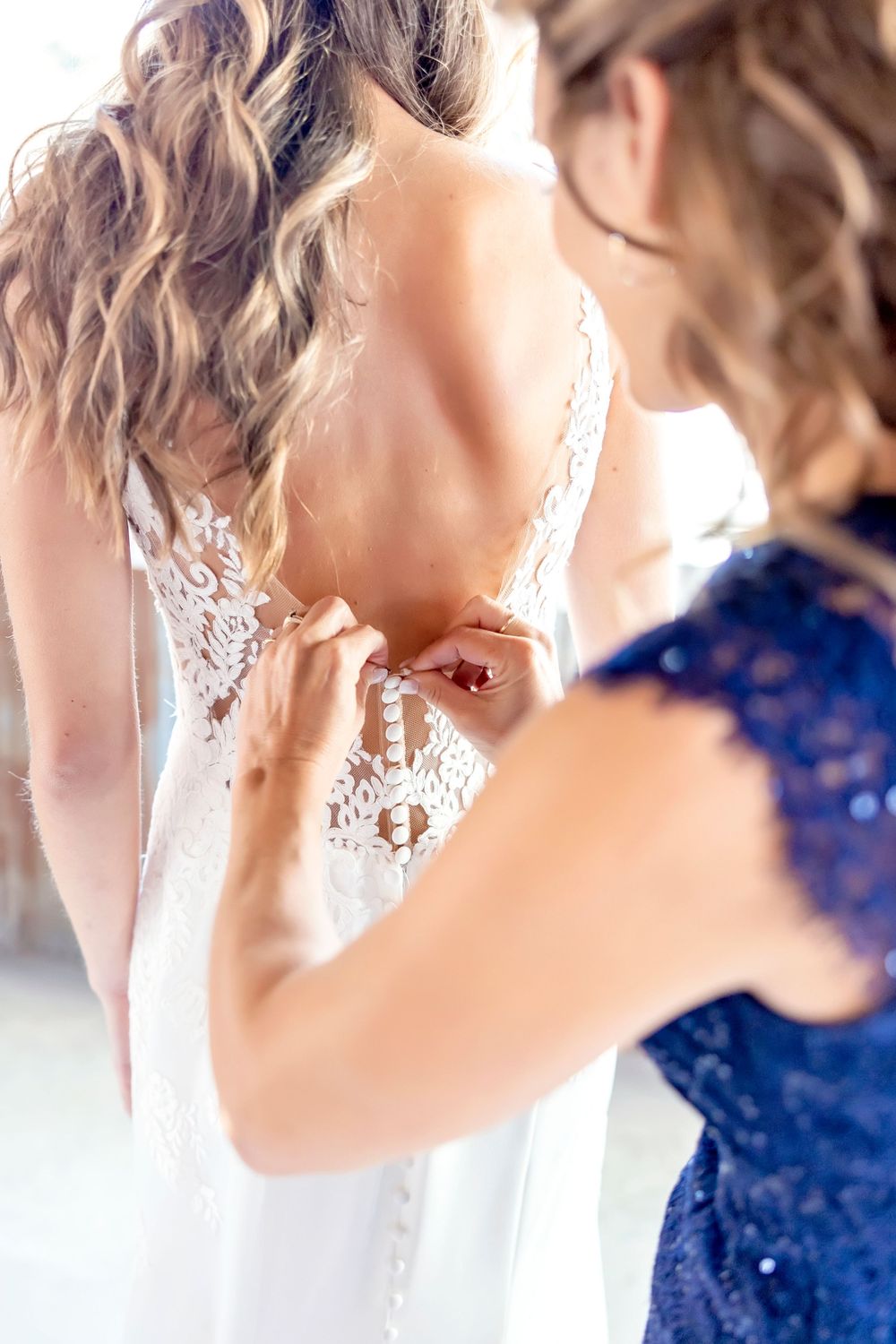 Elegant white lace detail against a soft peach background during a wedding celebration.