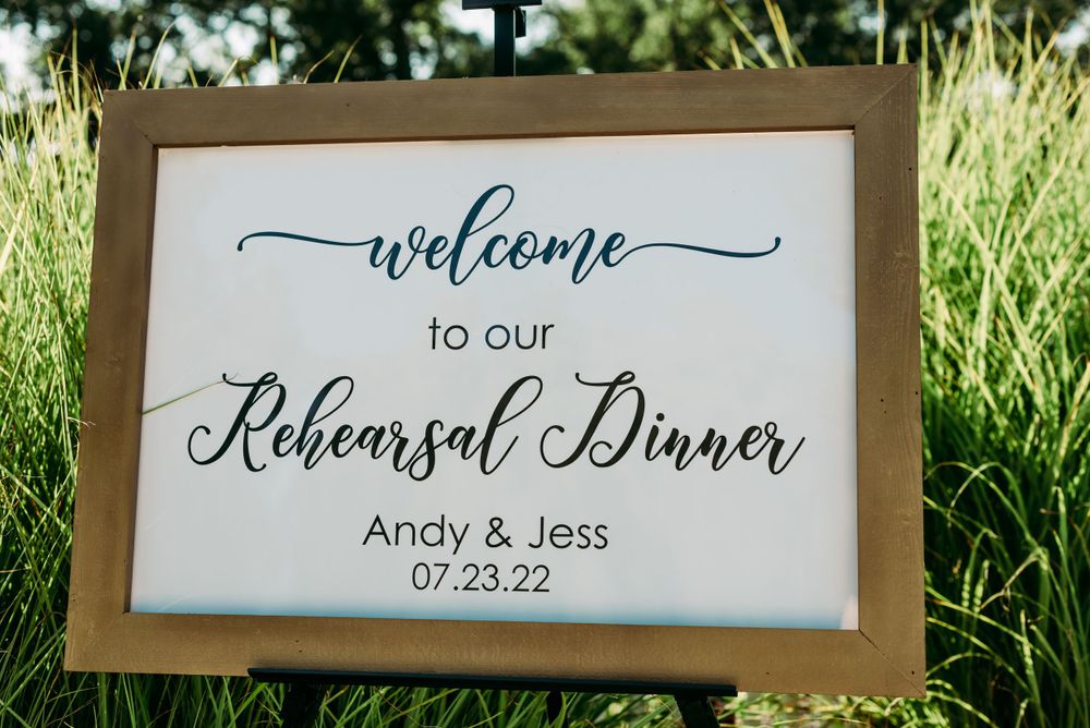 Welcome sign for a rehearsal dinner with elegant calligraphy and wooden frame.