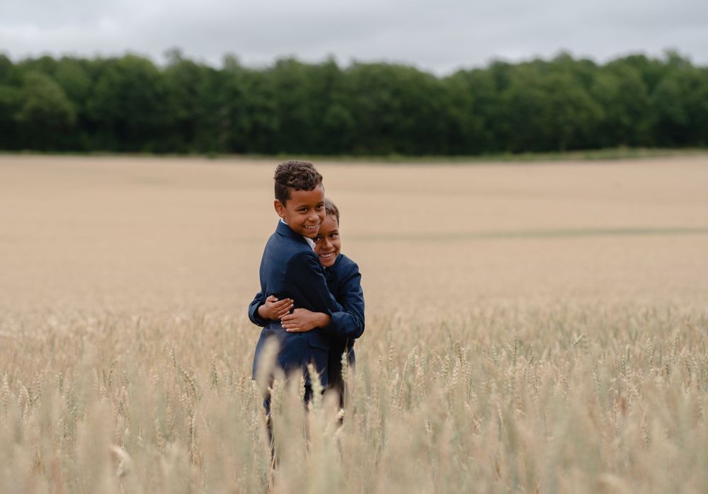 A romantic moment in a golden wheat field during sunset.