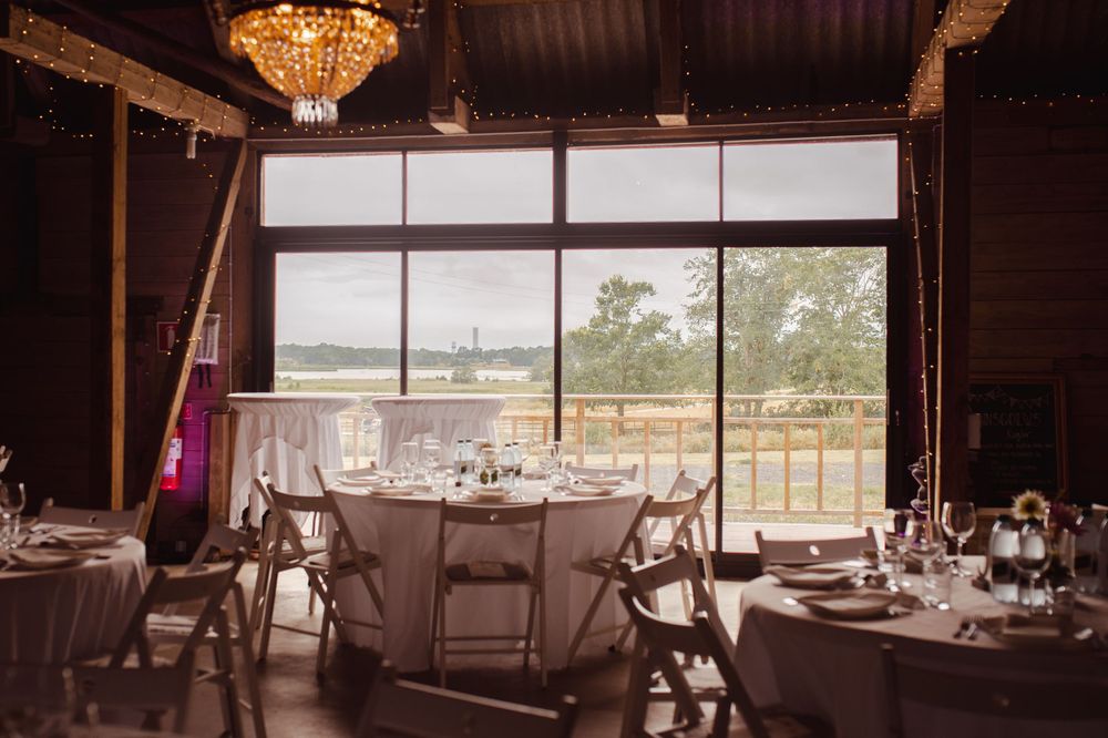 Elegant wedding reception venue with crystal chandelier and panoramic window views.