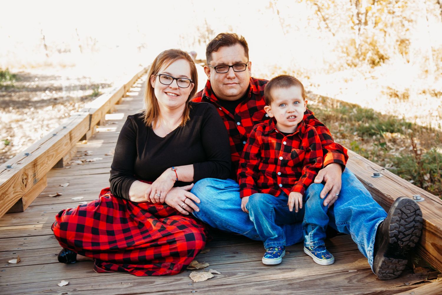 Family posed on bridge