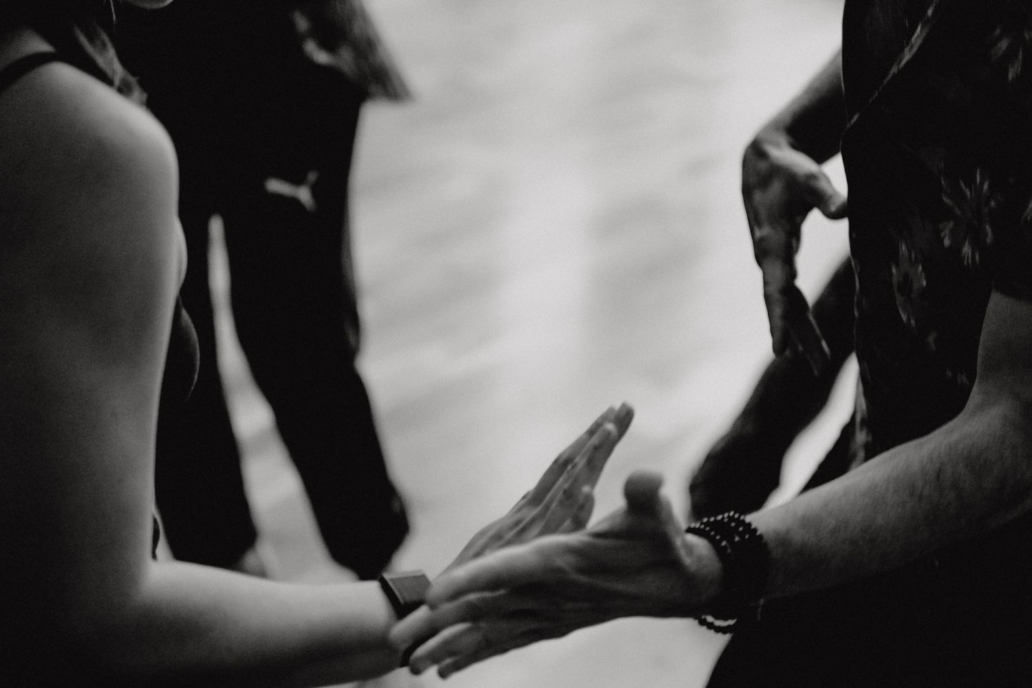 Black and white photograph of hands gesturing during what appears to be a conversation.