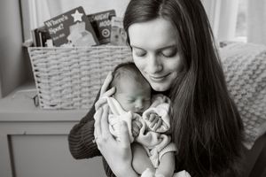 Black and white photo series showing tender moments between mother and baby.