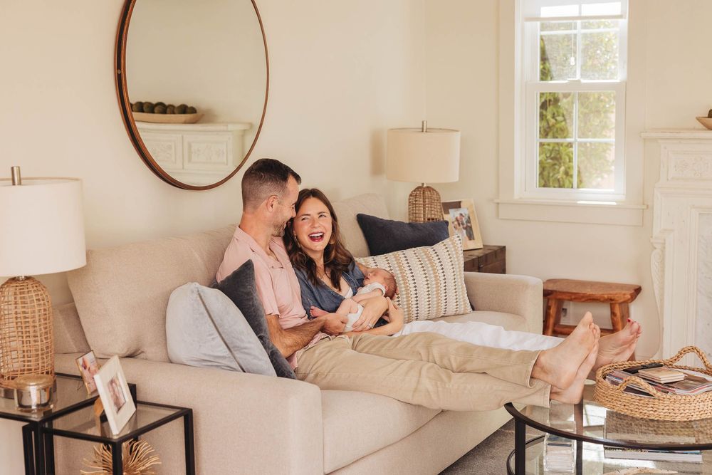 Family sharing tender moments and quality time together in a bright, modern living room with a cozy sectional sofa.