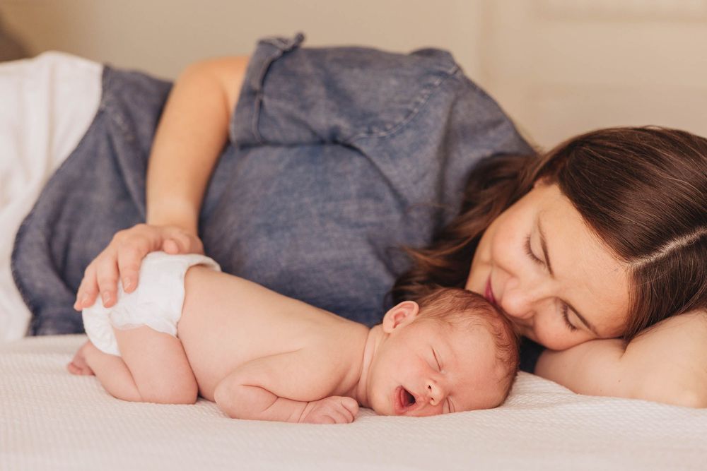 A series of progressive photos showing a mother and baby laying together in peaceful bonding moments on a bed.