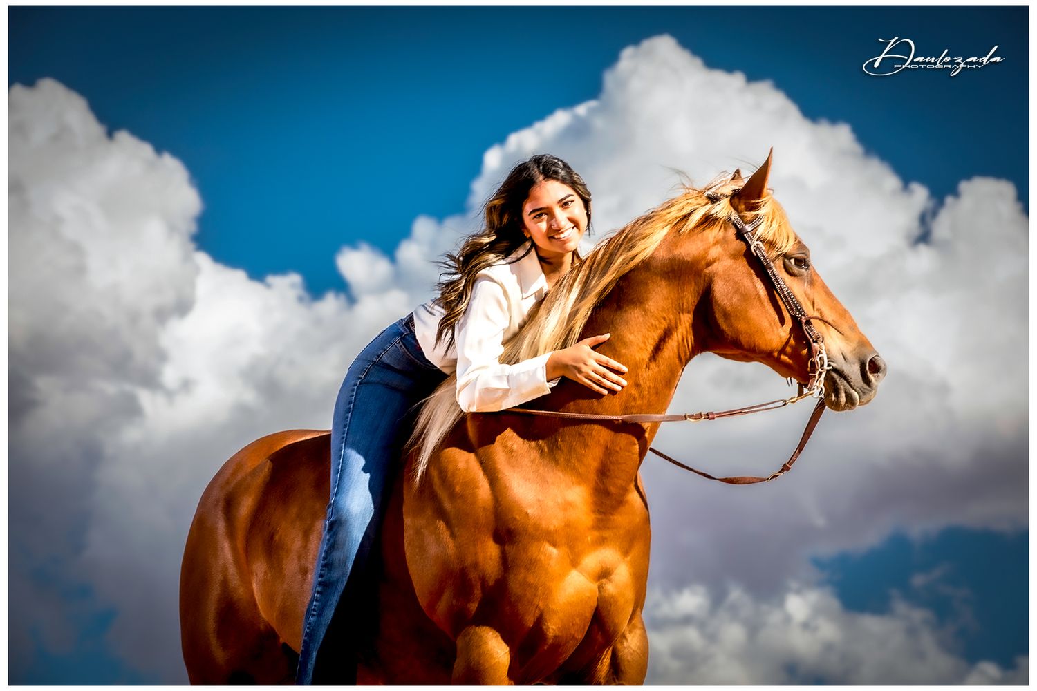 Senior portraits in El Paso – Class of 2025 graduate riding a horse at Red Sands with a bold desert backdrop.