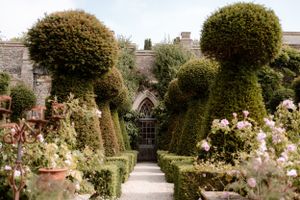 View of the gardens and topiary at Euridge Manor, luxury Cotswolds wedding venue