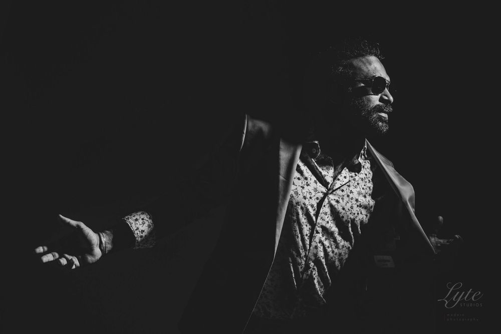 Artistic black and white performance capture showing dramatic gestures and movement.