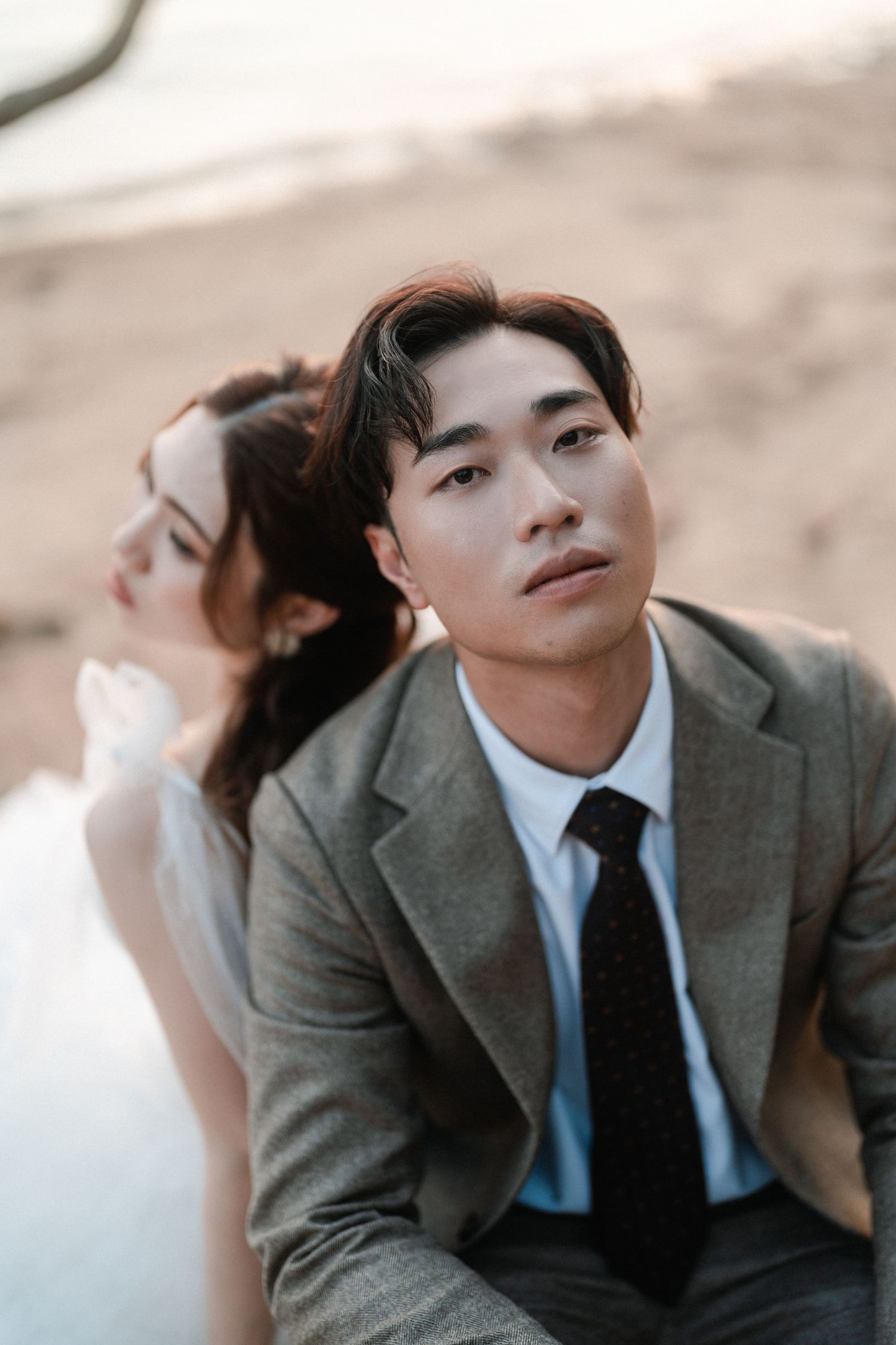 Romantic couple portrait at sunset in formal attire.