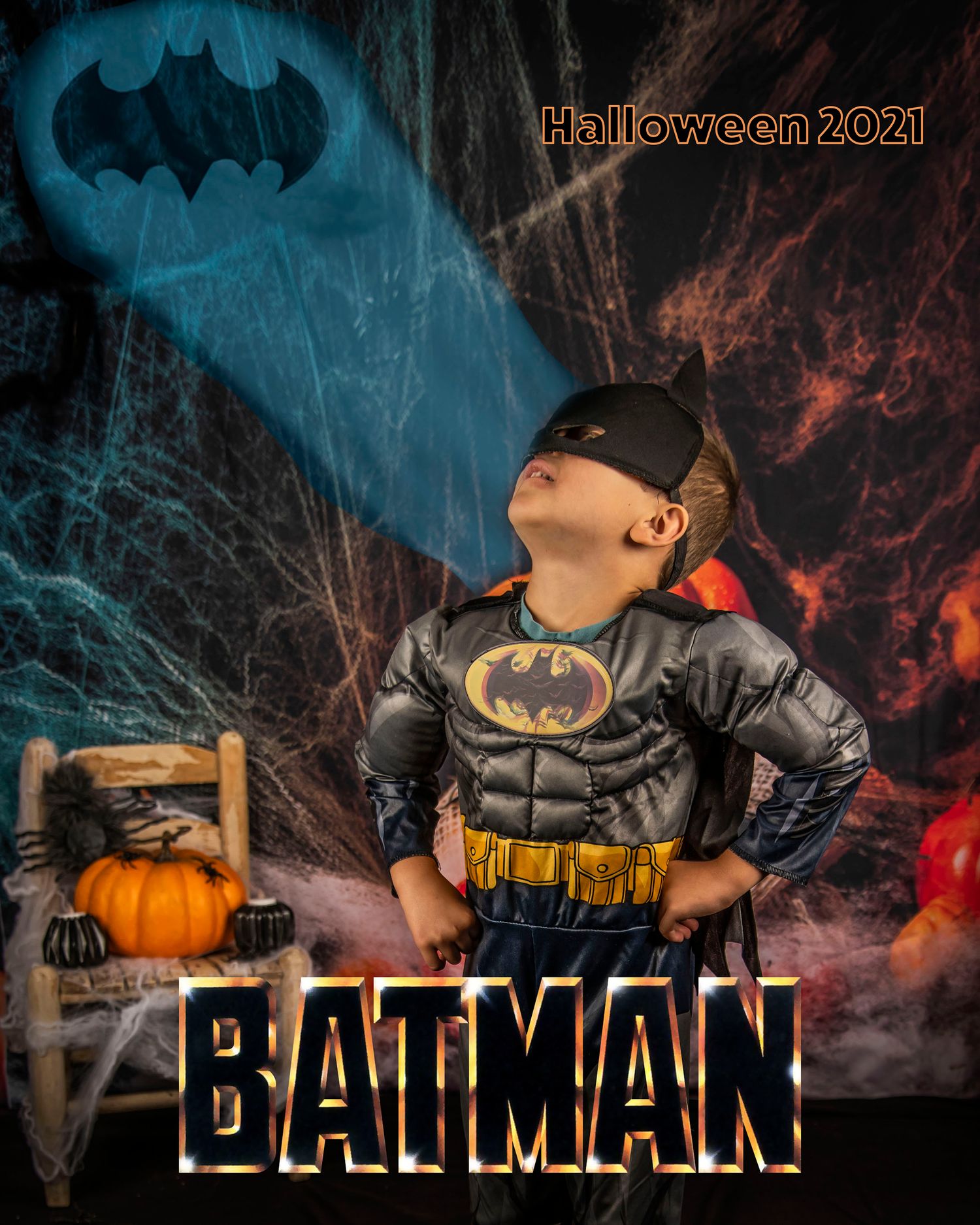 Batman costume portrait with Bat-signal and dramatic lighting against spooky background.