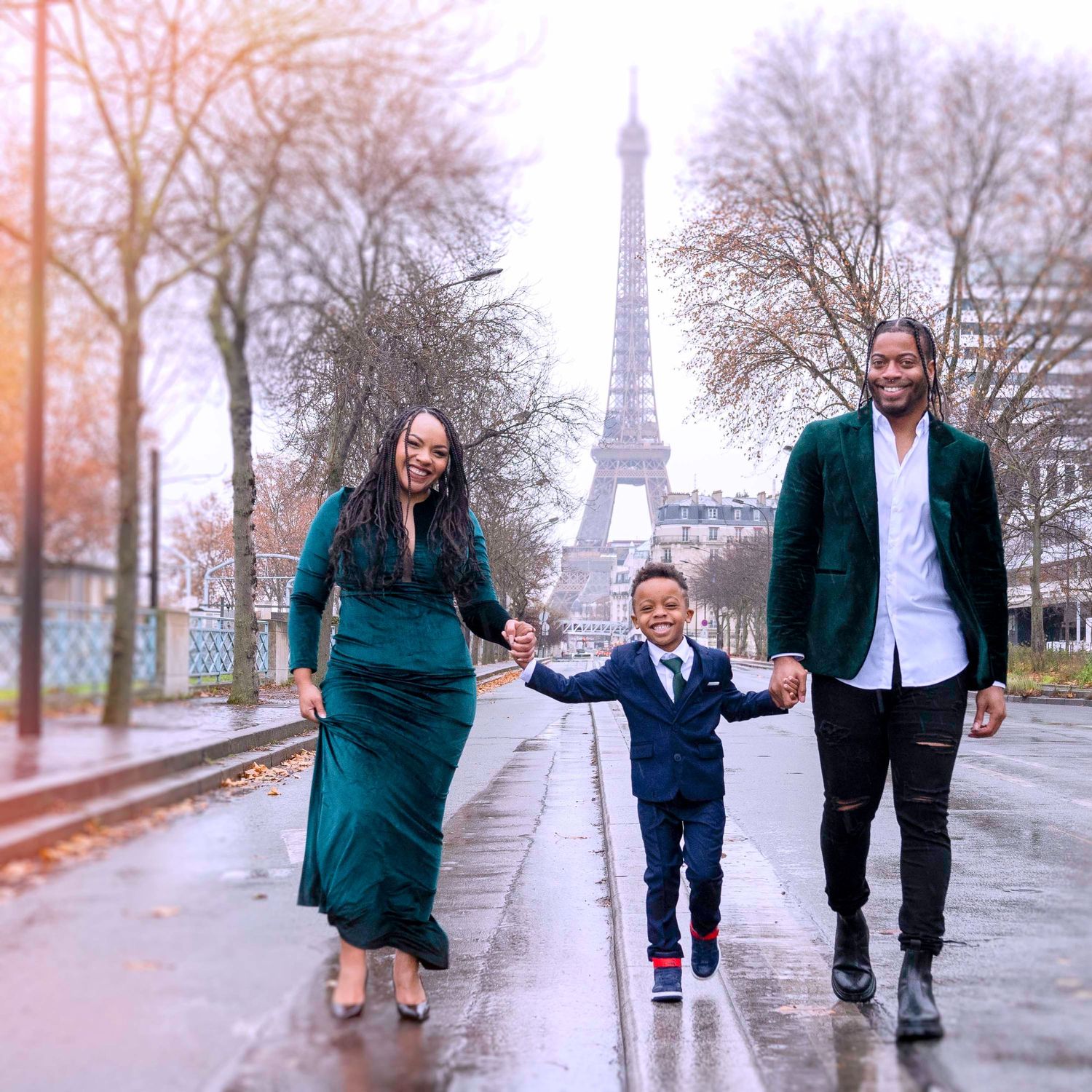Black familiy walkig in front of Eiffel Tower