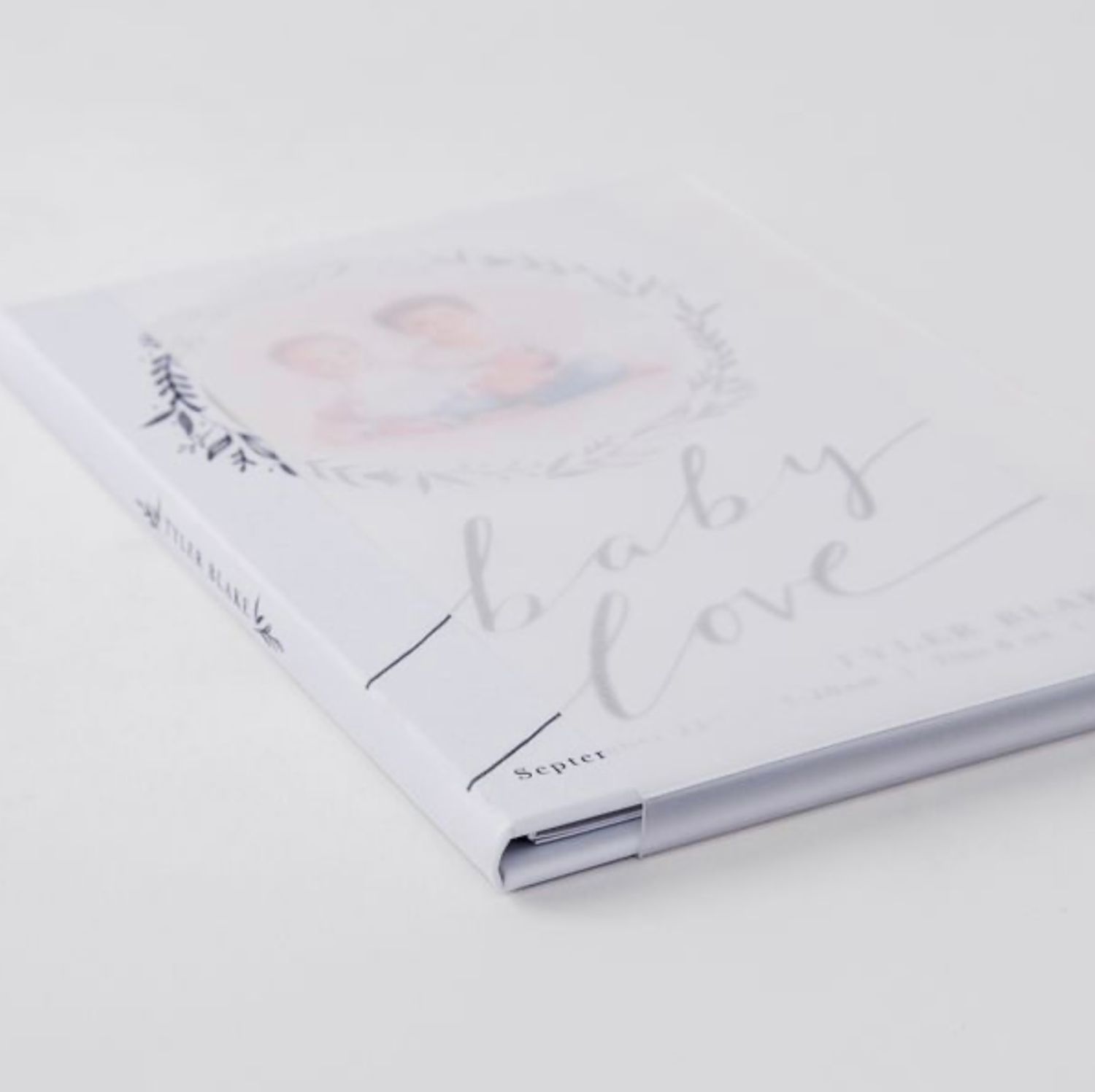 Minimalist white photo album or book cover displayed at various angles.
