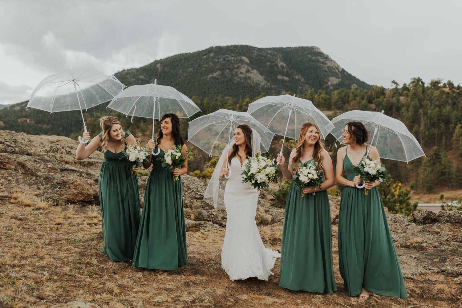 Bridesmaids in the rain with umbrellas