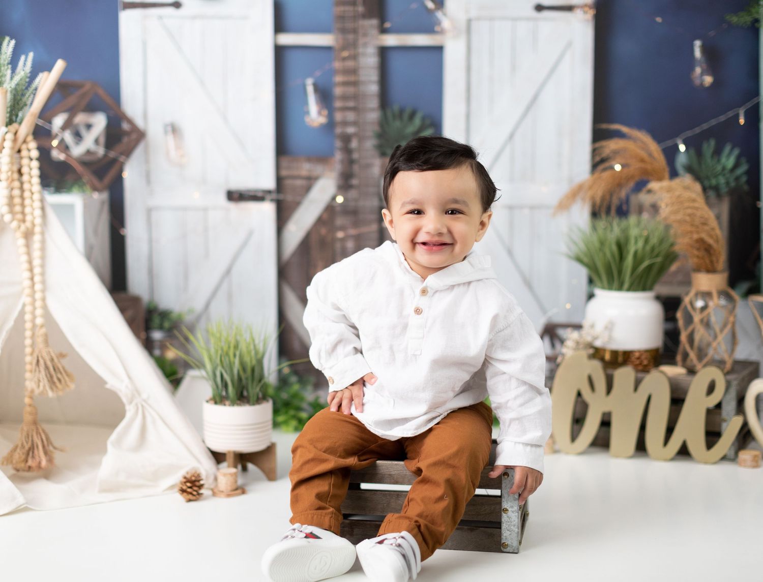 White and brown themed photography setup with rustic barn door backdrop.