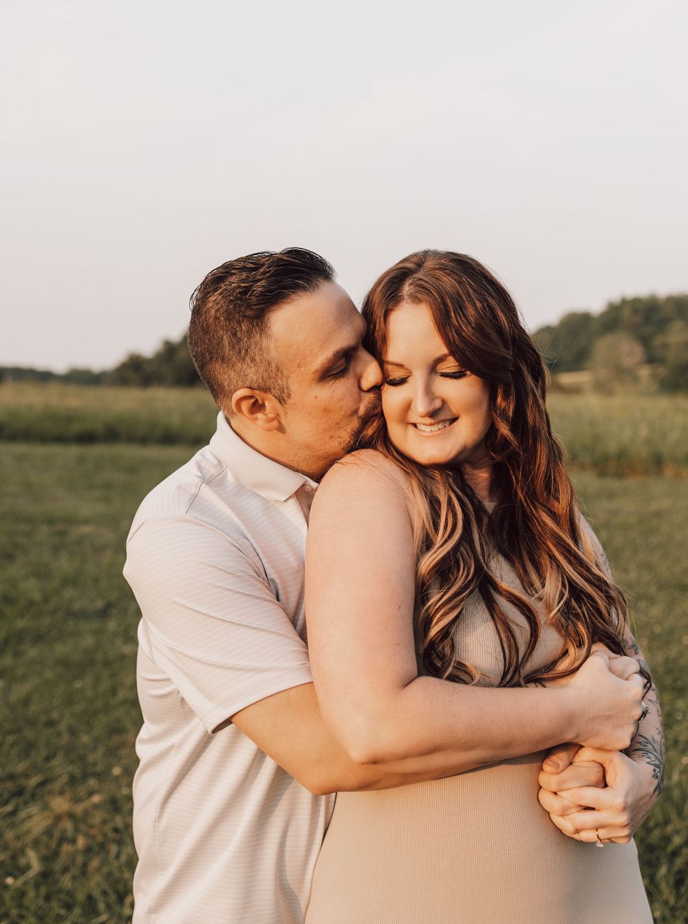 engaged couple hugging tight