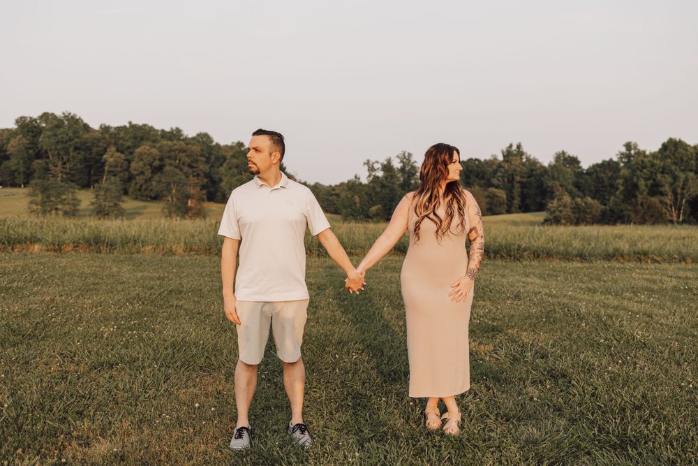 couple holding hands field photo