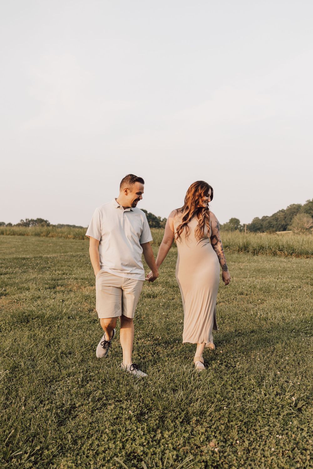 couple walking through field