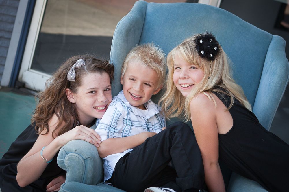 Group of friends sharing a casual moment together on blue furniture.