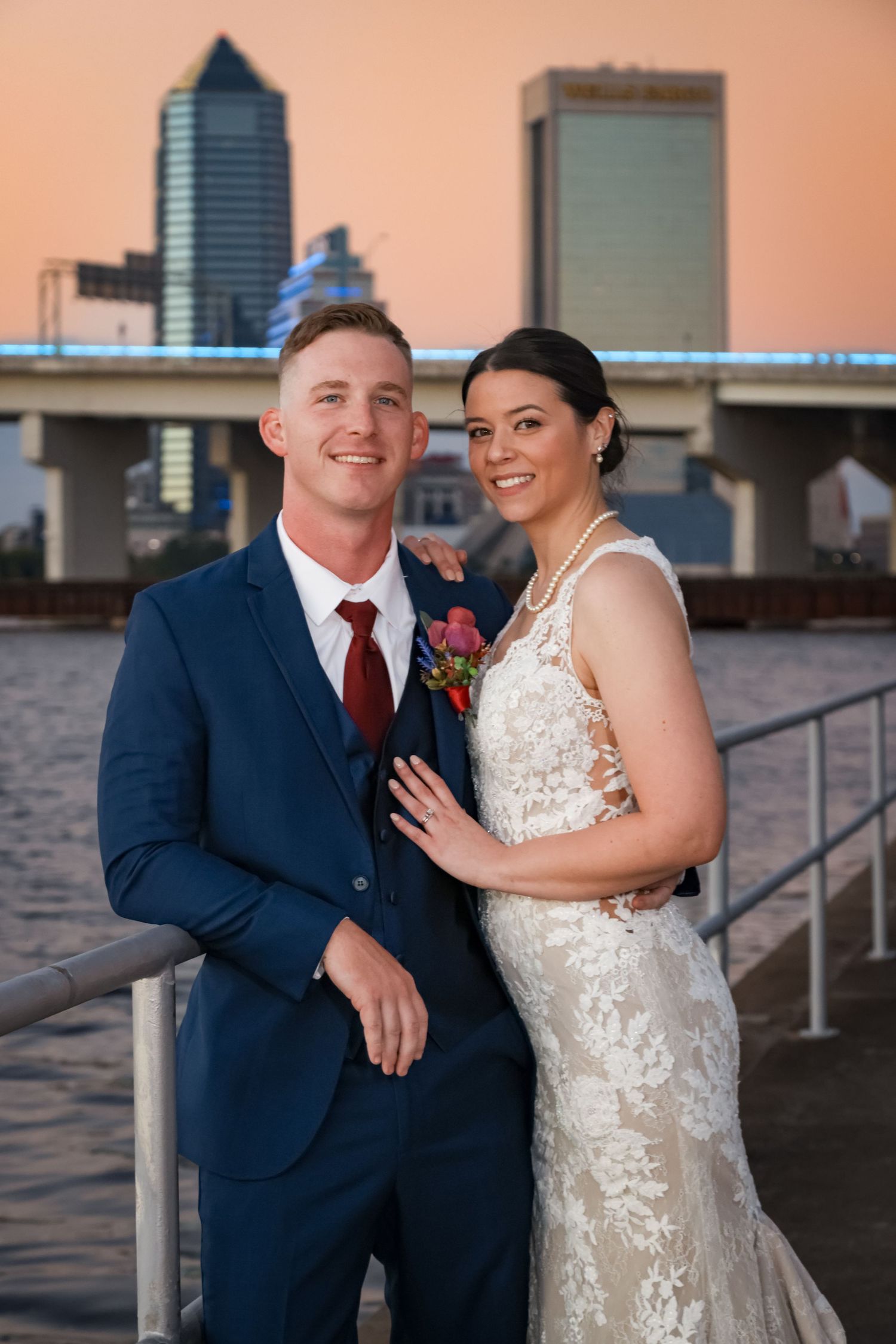 A sunset portrait on Jacksonville's waterfront with city skyscrapers in the background.
