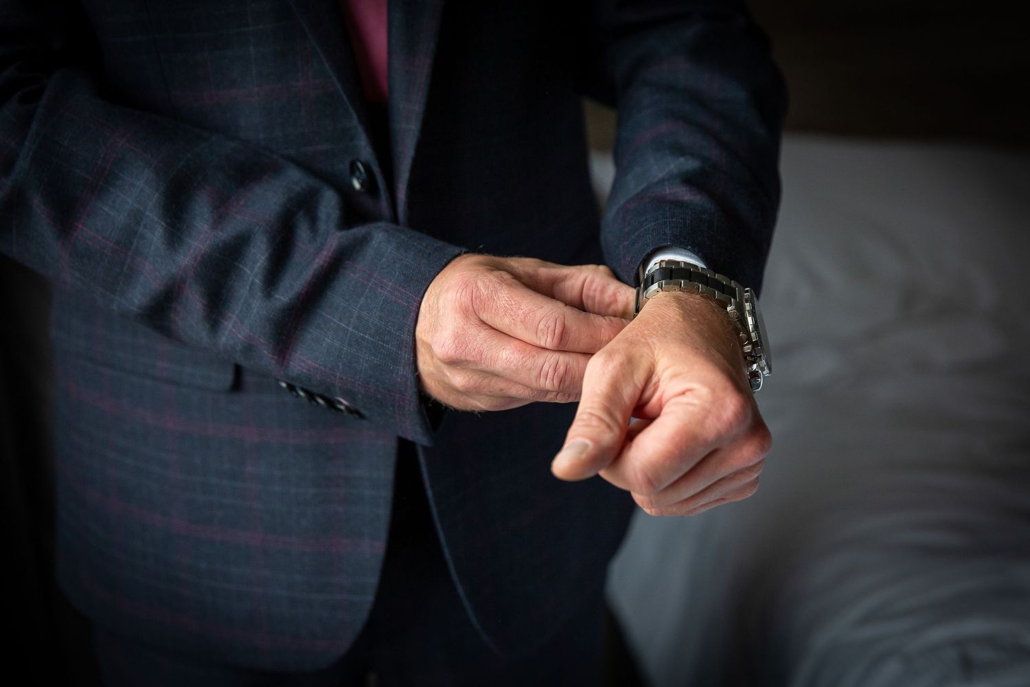 Close-up of the groove fastening a cufflink on his shirt. Crowne Plaza hotel. Liverpool wedding photographer
