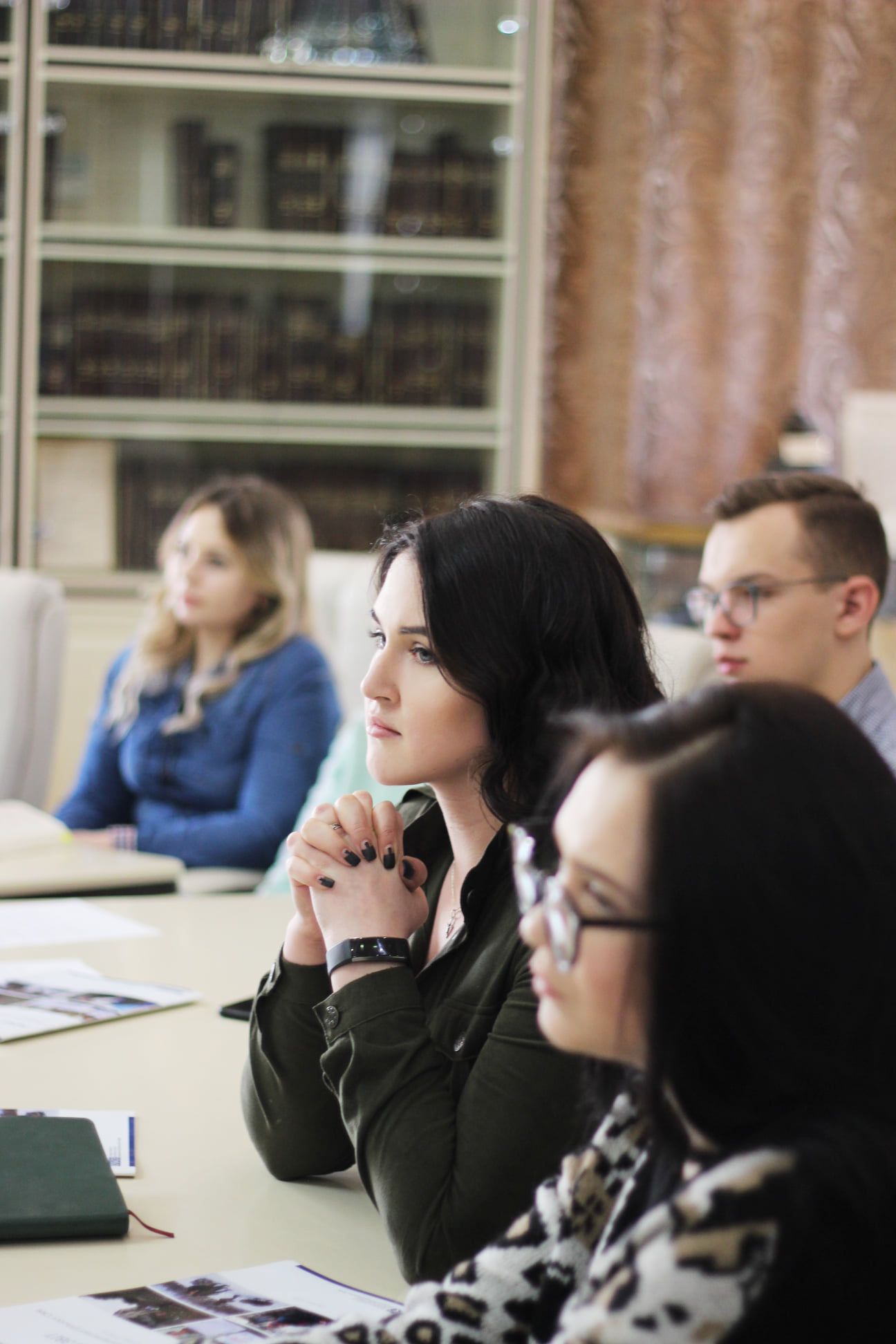 Attentive students sitting at a conference table during an educational session.