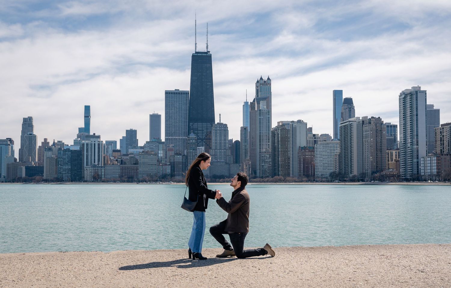 Marriage proposal with Chicago skyline backdrop at North Avenue Beach.