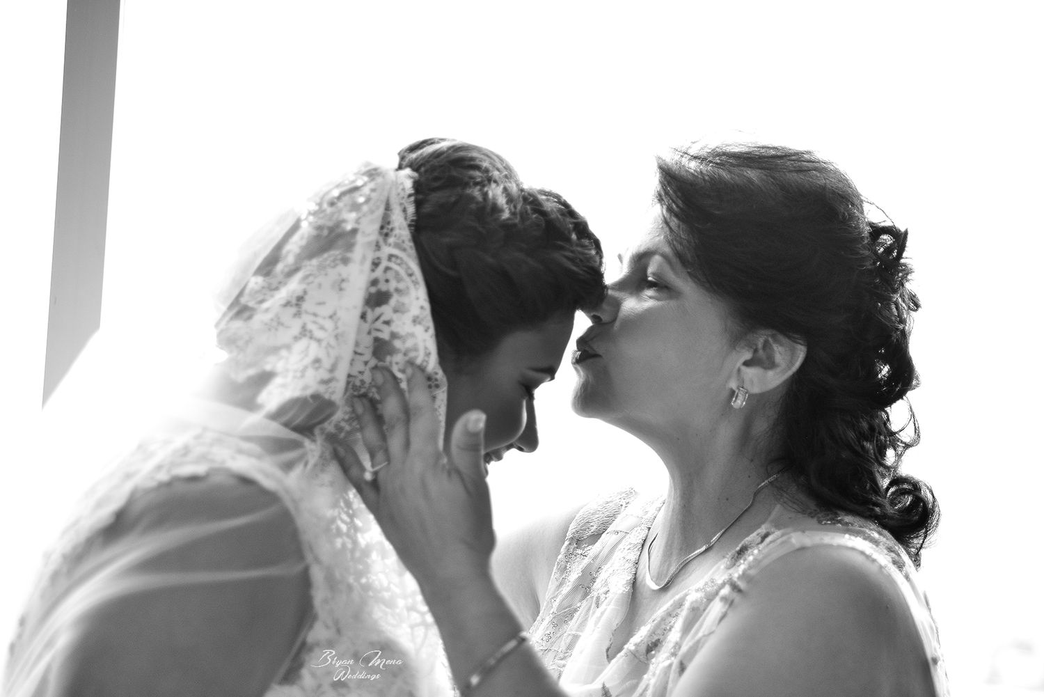 mother and daughter beautiful kissing wedding photography