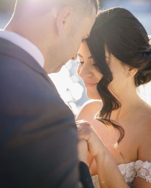 An intimate moment between newlyweds captured in warm sunlight.